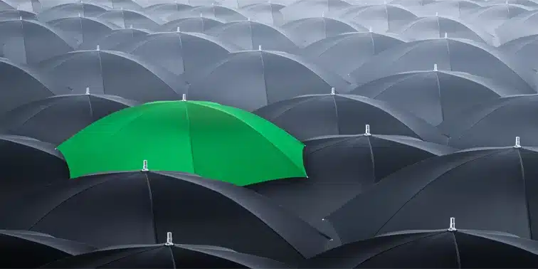 Black Umbrellas With a Green Umbrella Standing Out - Smart Cow Marketing Digital Marketing Croydon
